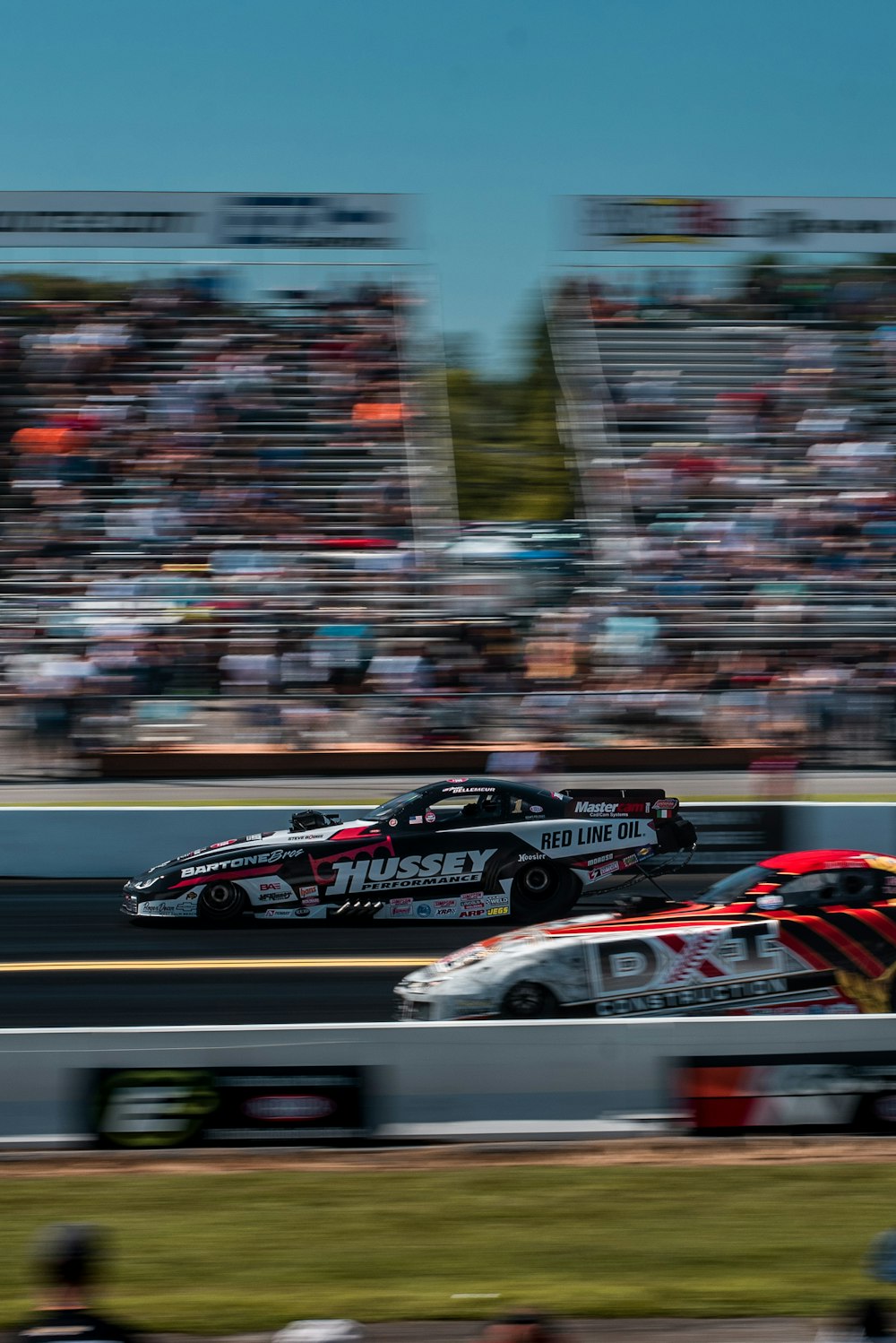 time-lapse photography of cars passing in a race track