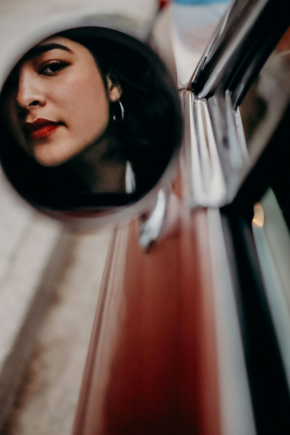 woman wearing red lipstick reflection on mirror