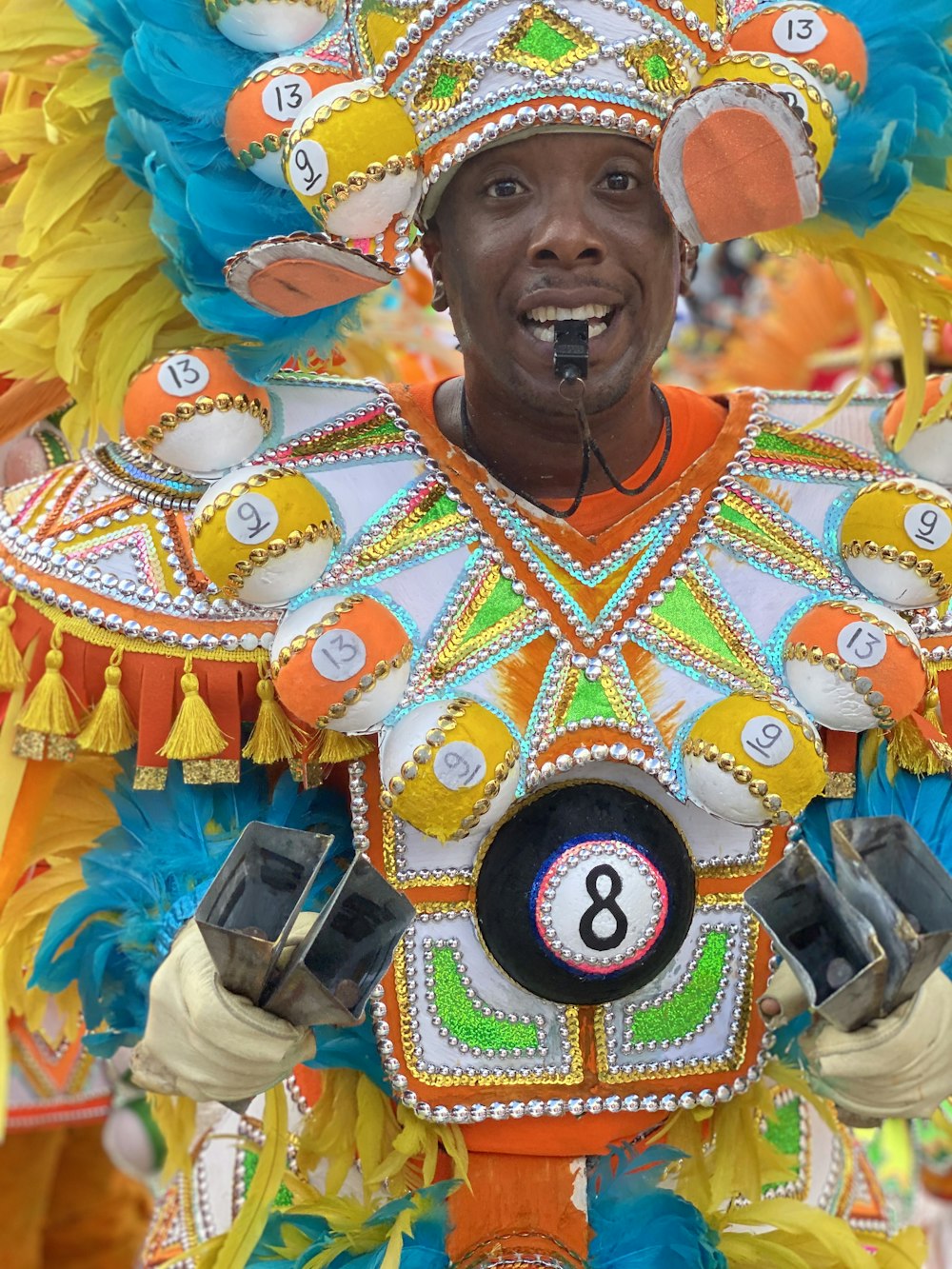 man wearing white, green, and orange costume with number 8 tag