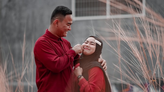 man pinching woman's cheek in Depok Indonesia