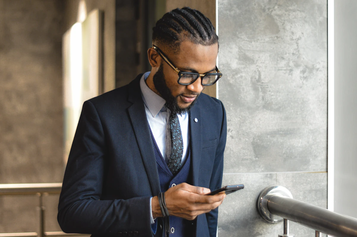 Nigerian landlord holding a phone