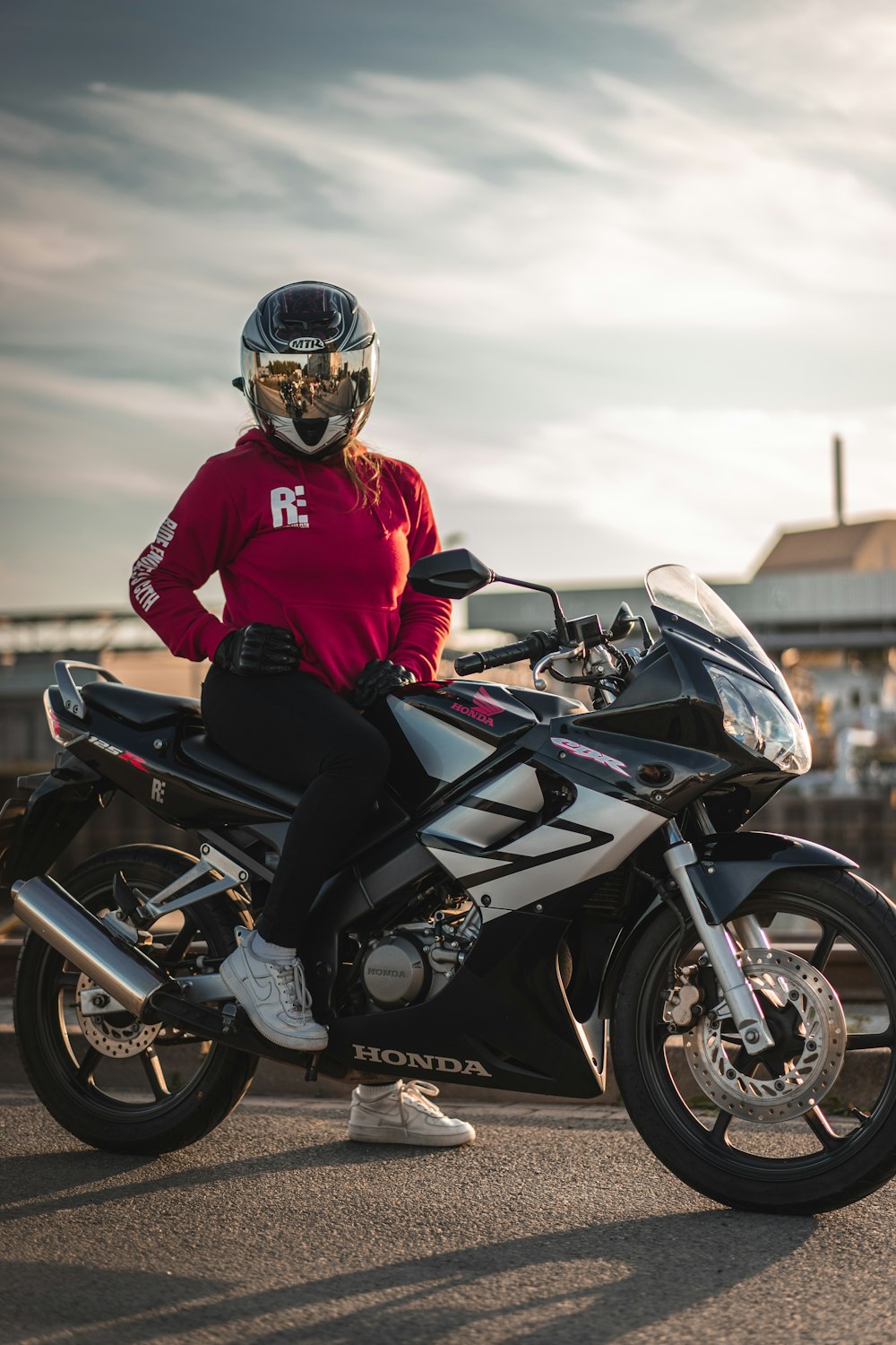 person sitting on Honda sports bike during day
