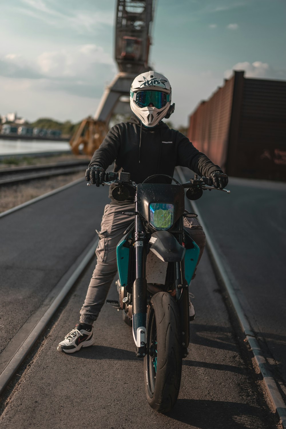 man wearing black leather jacket riding motocross dirt bike