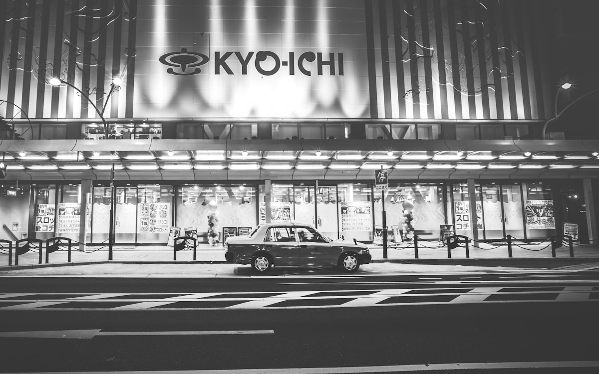 grayscale photo of cars on road
