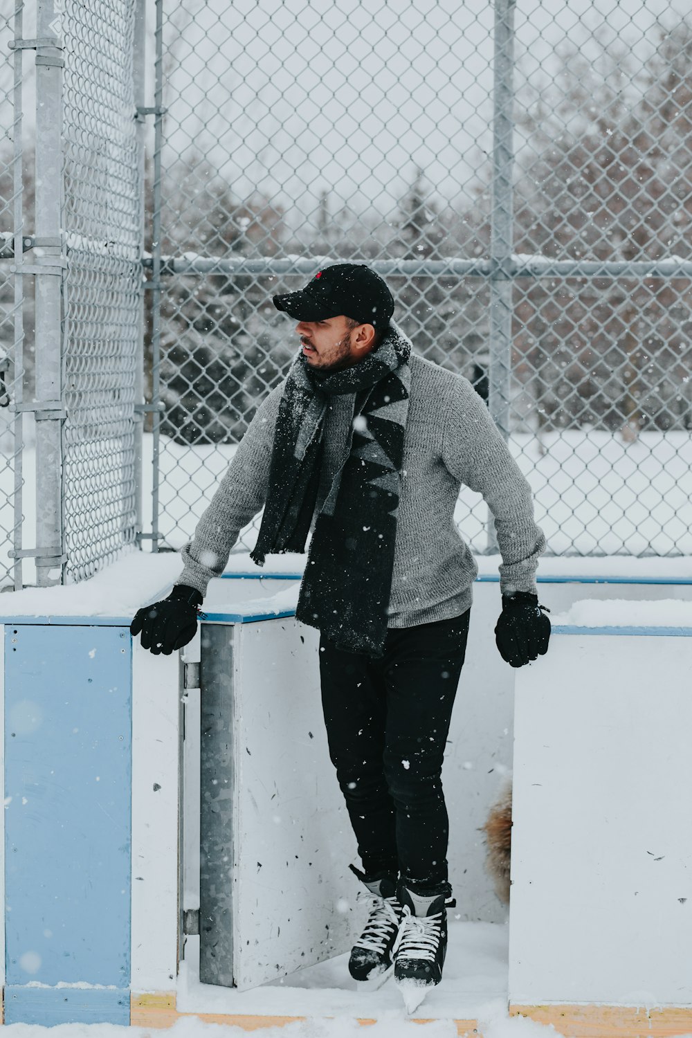 man in gray jacket and black pants standing