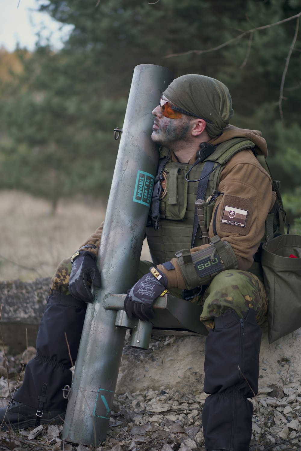 soldier man wearing tactical vest sitting while looking up