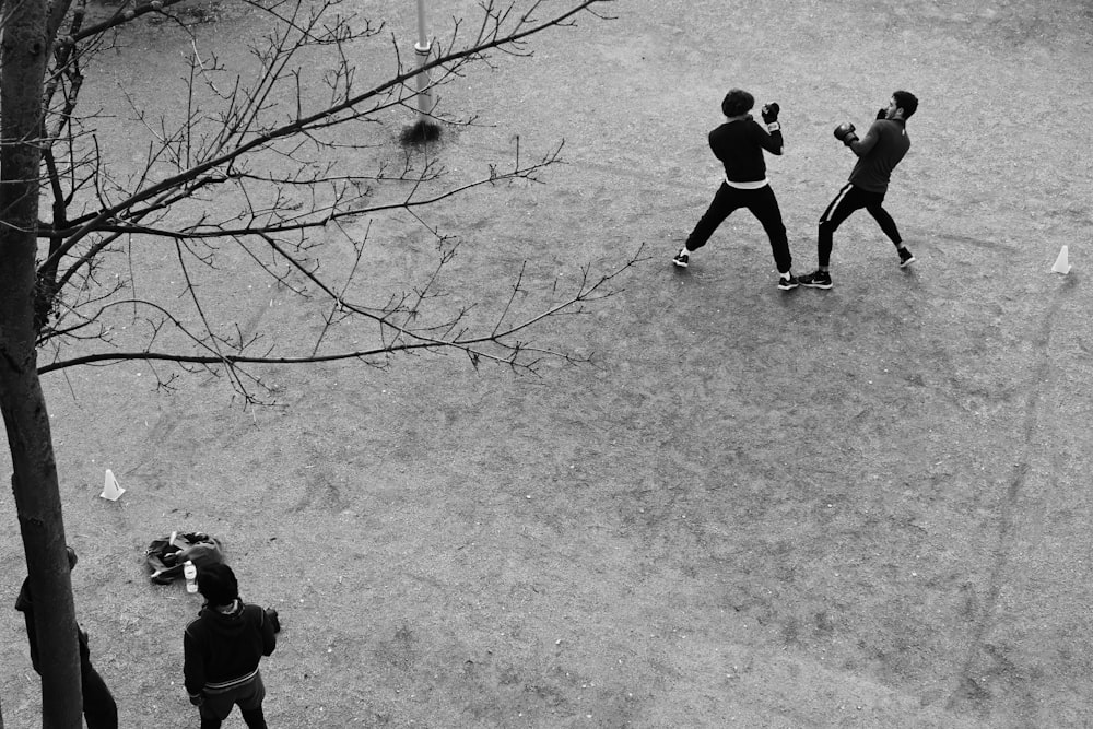 grayscale photography of two people boxing on field