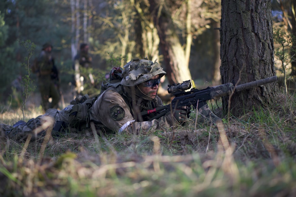 man aiming rifle