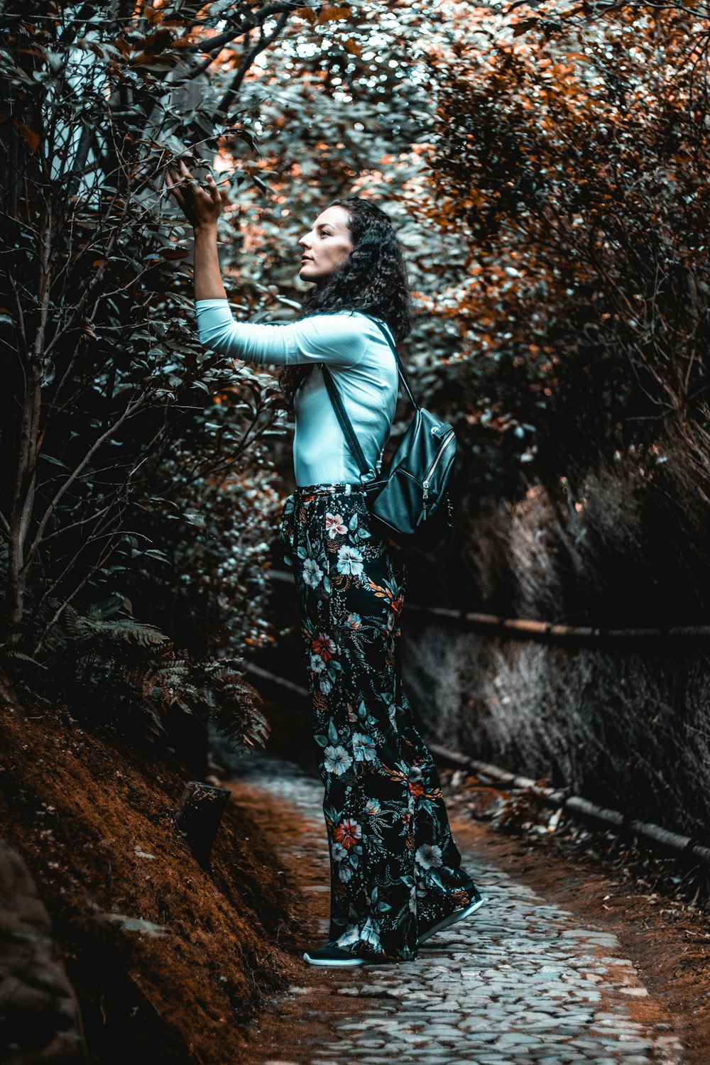 woman standing in front of green-leafed tree