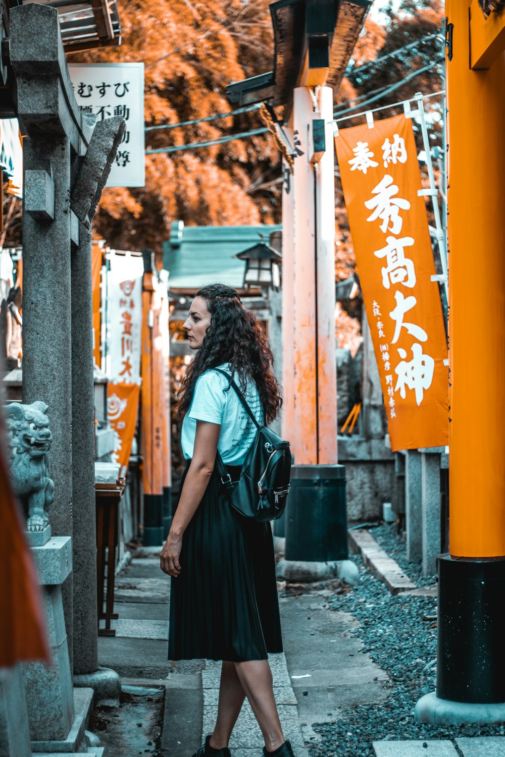 woman stands near tori gates