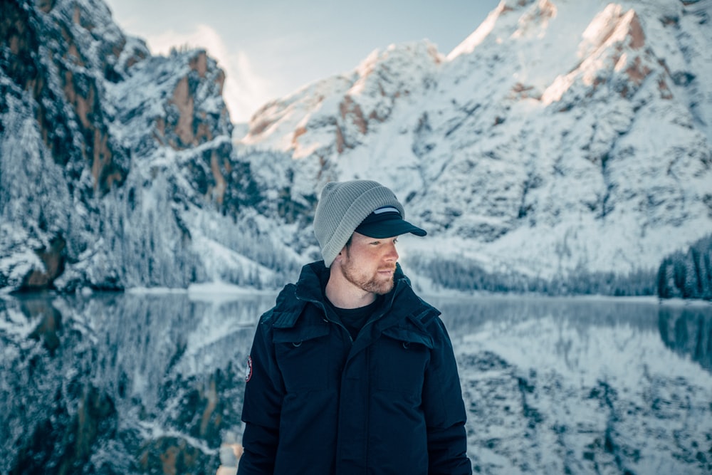 selective focus of man standing beside seashore during daytime