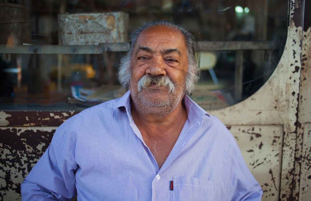 man leaning on metal wall