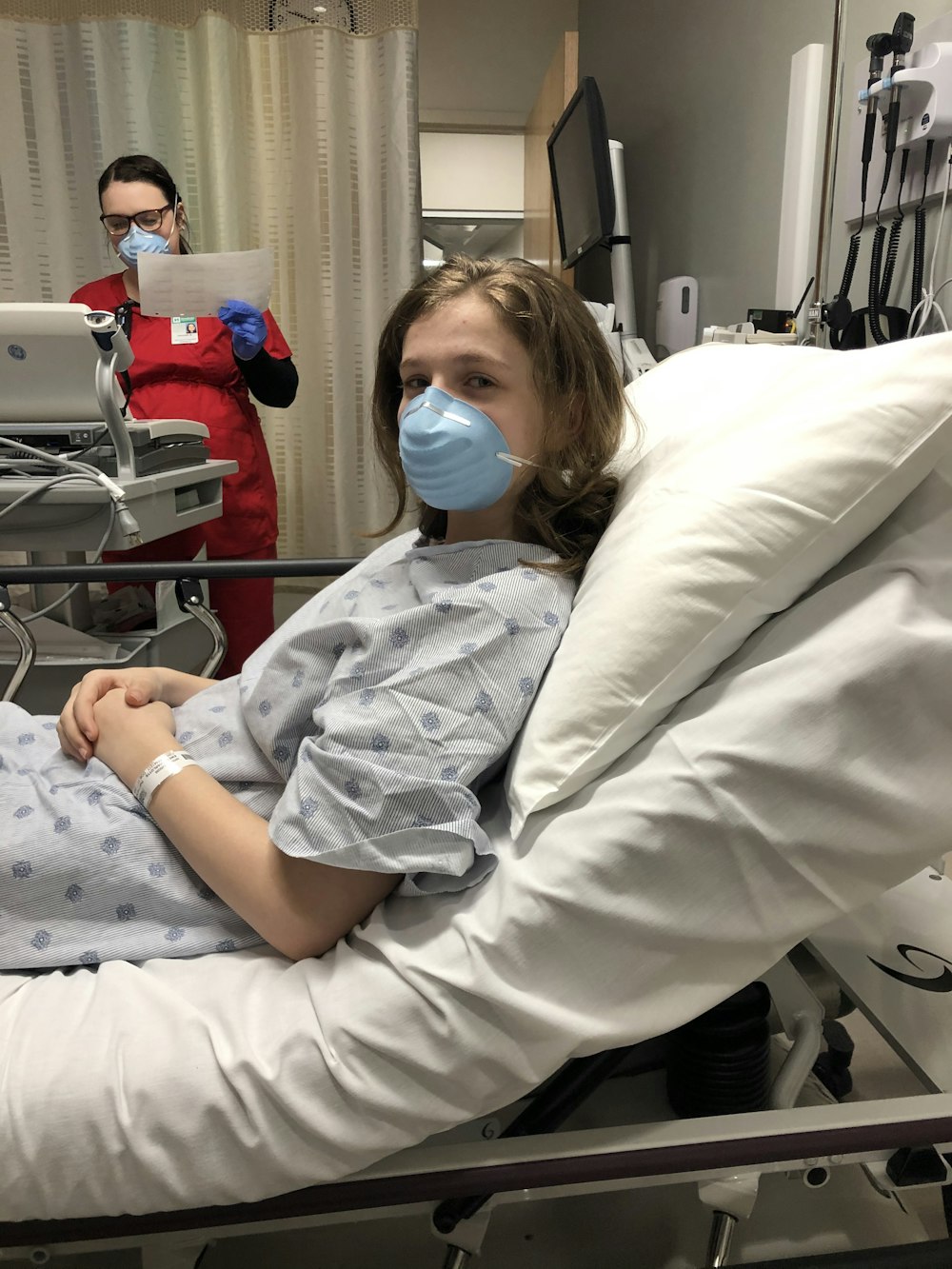 woman lying on hospital bed