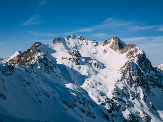 snow covered mountain under blue sky during daytime in Luz-Saint-Sauveur France