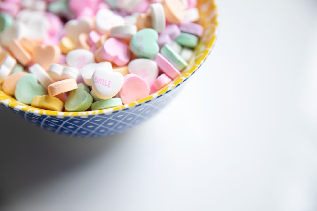 minimalist photography of bowl of heart-shaped candies