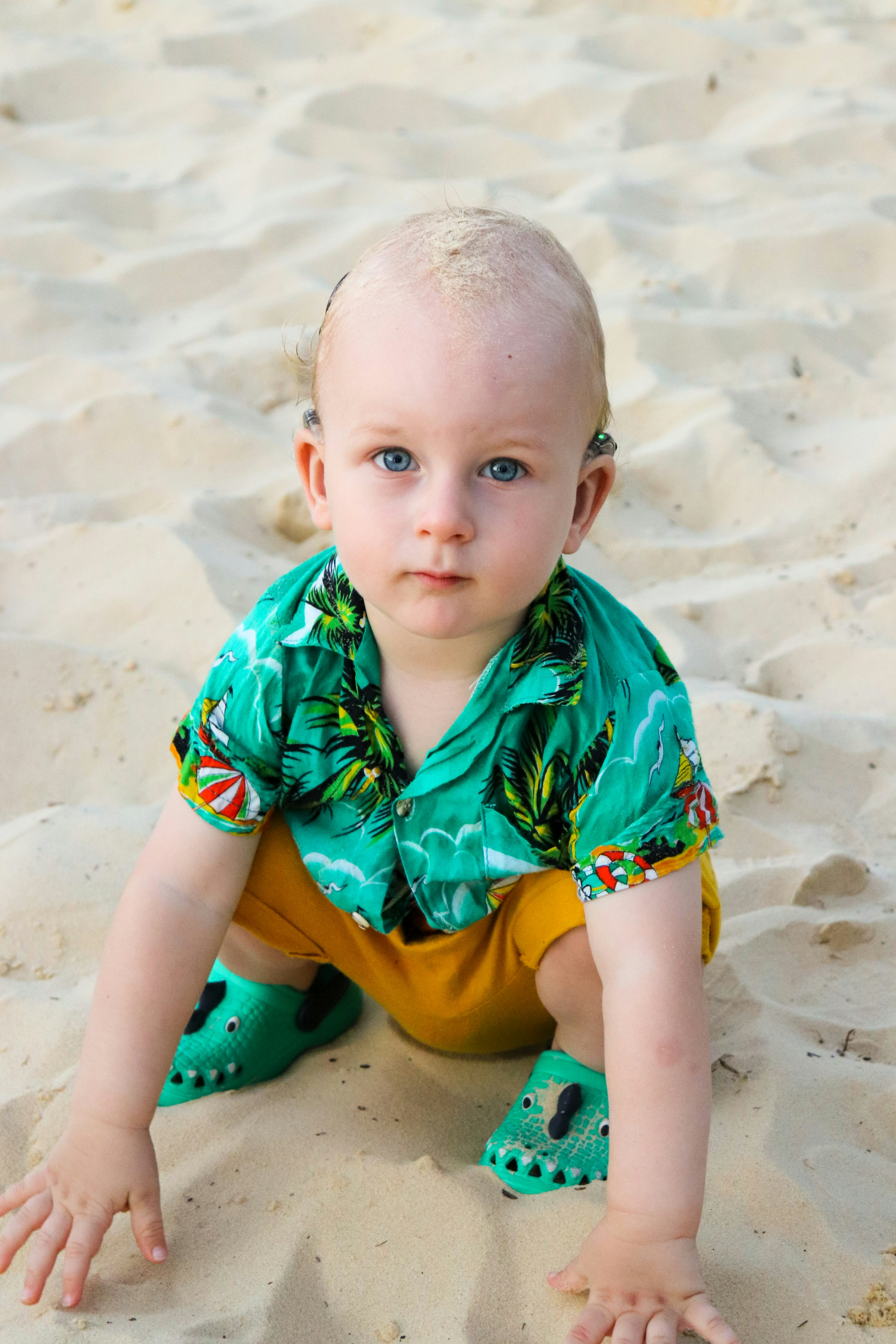 toddler in green button-up T-shirt