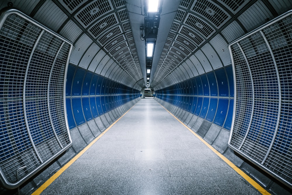 a long hallway with blue and yellow doors