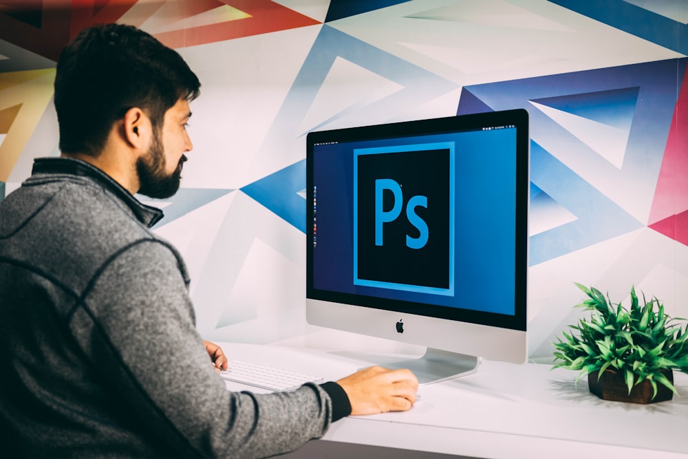 man using silver iMac