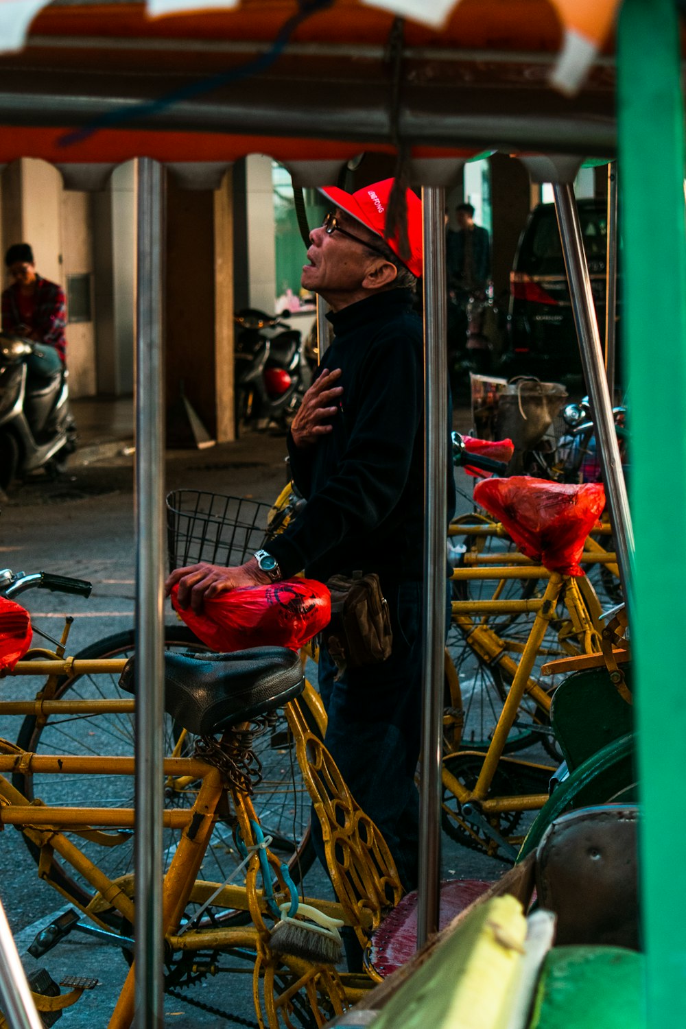 man standing by parked bicycles at daytime