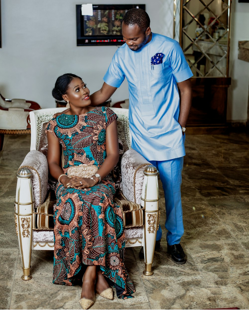 woman sitting on padded chair beside man