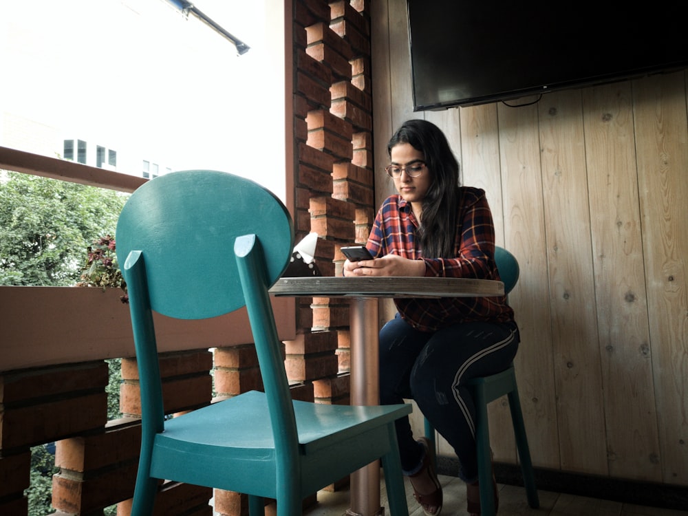 woman leaning on pedestal table