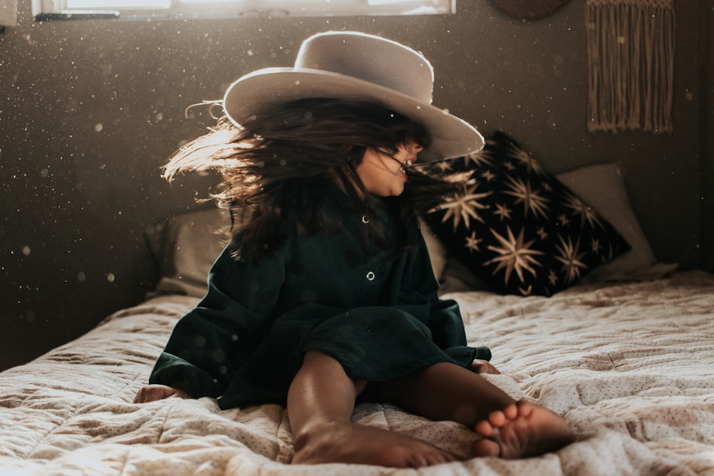 girl sitting on bed