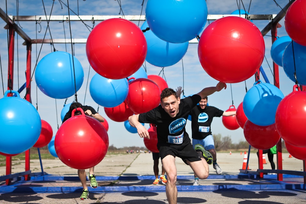 group of people on red and black obstacle course