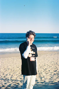 A friendly customer service agent speaking on a headset with a backdrop of a sunny Florida coastline.