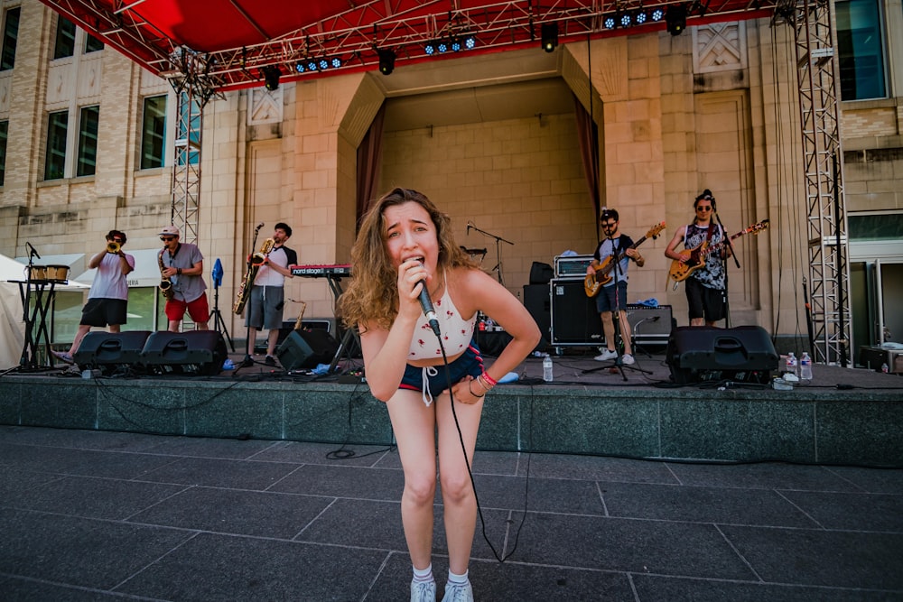 woman singing on stage