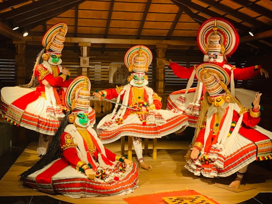 five people wearing multicolored costumes while dancing in Kochi India