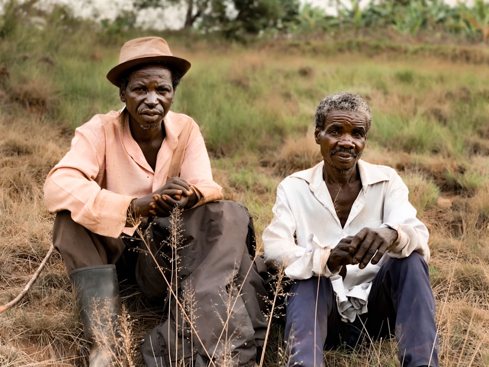 two men sitting on ground