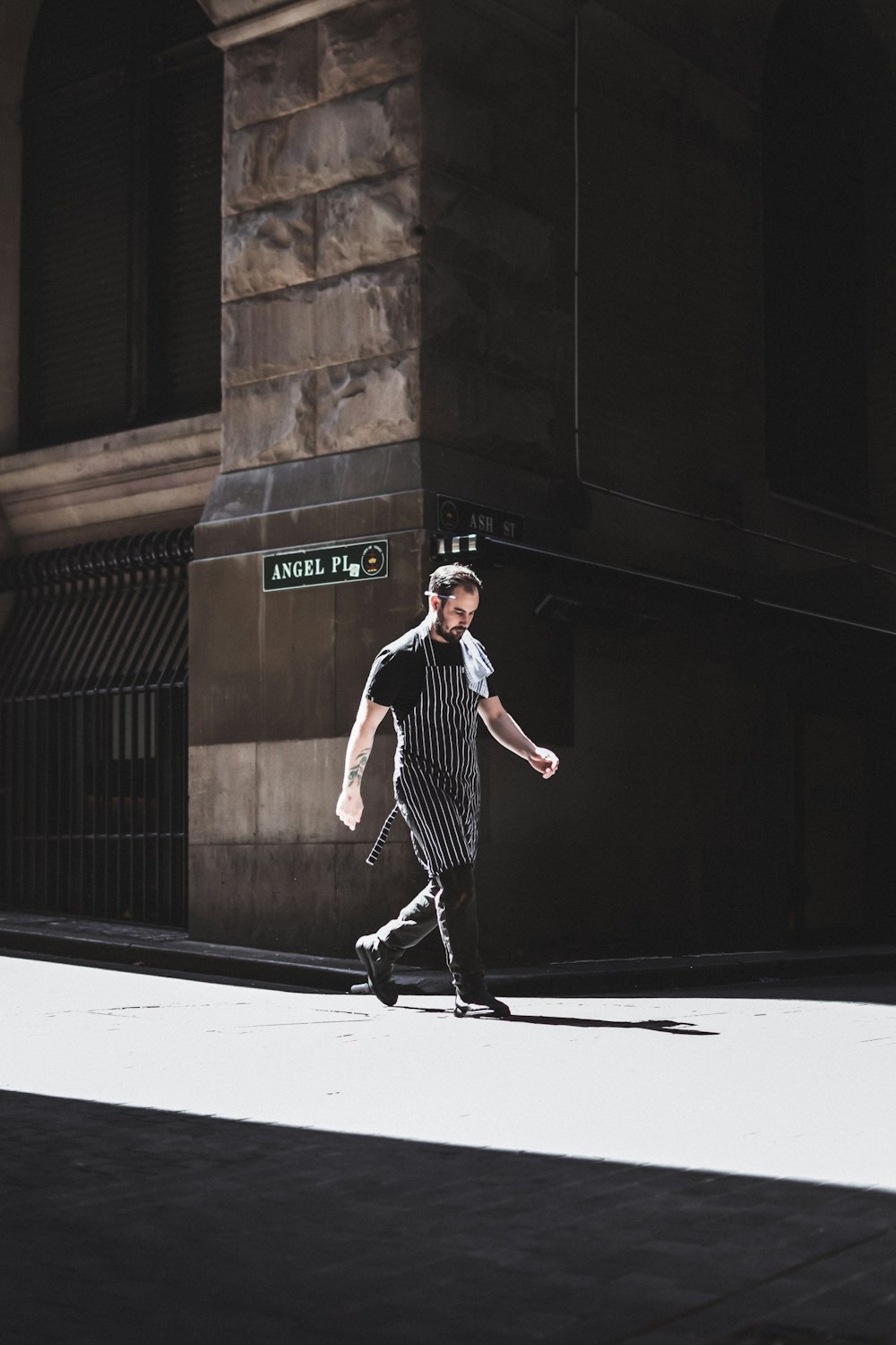 man standing near brown building