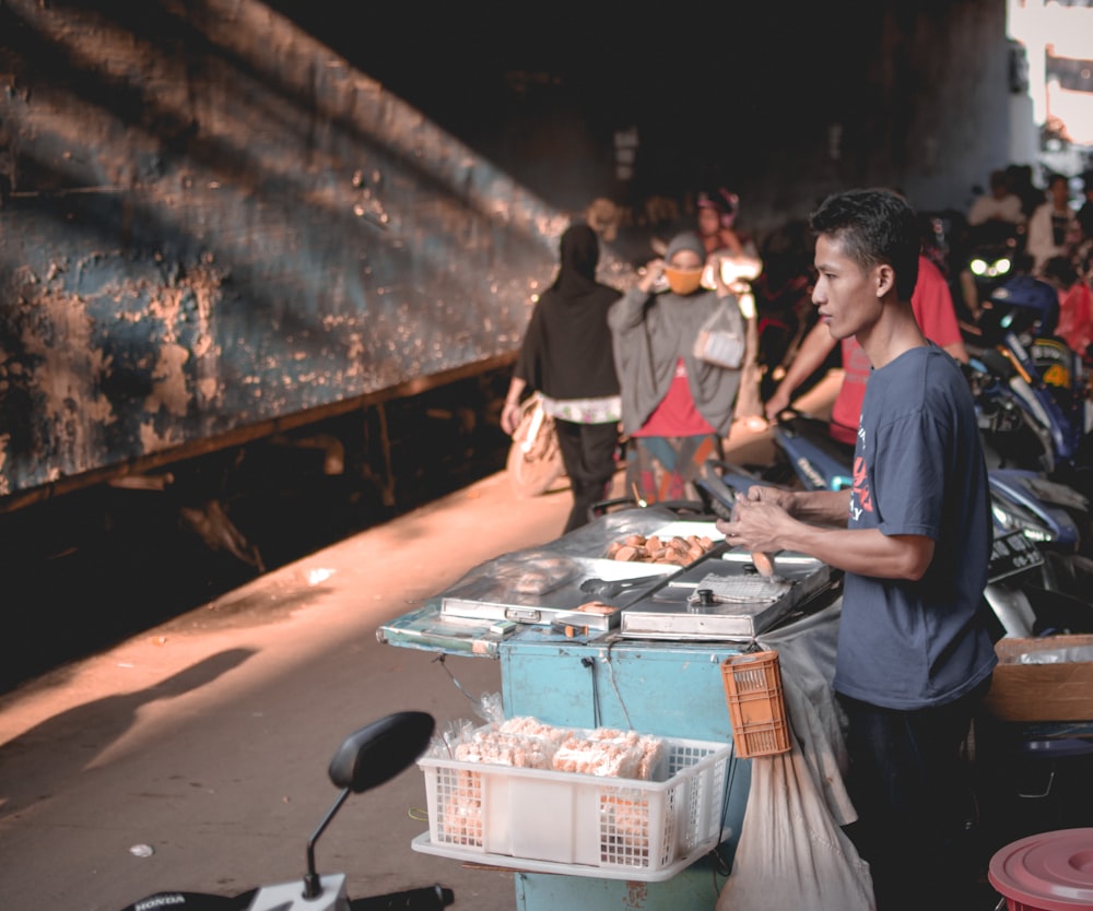 man standing behind display stall