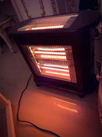 A sleek, modern heater softly glowing in a cozy living room.