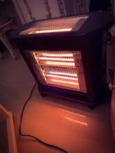 Technician installing a modern heating system in a cozy living room.