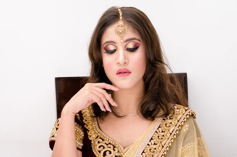 elegant woman in a black and gold sari