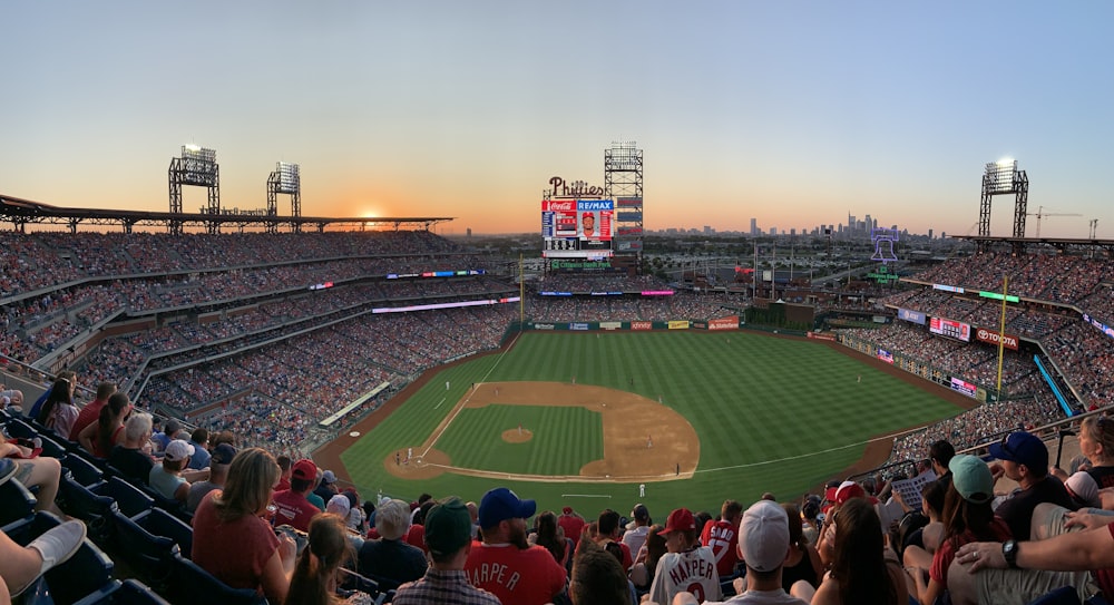 crowd inside baseball stadium during golden hour