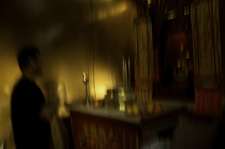 Dark mystical altar with candles and esoteric symbols glowing in blue light.