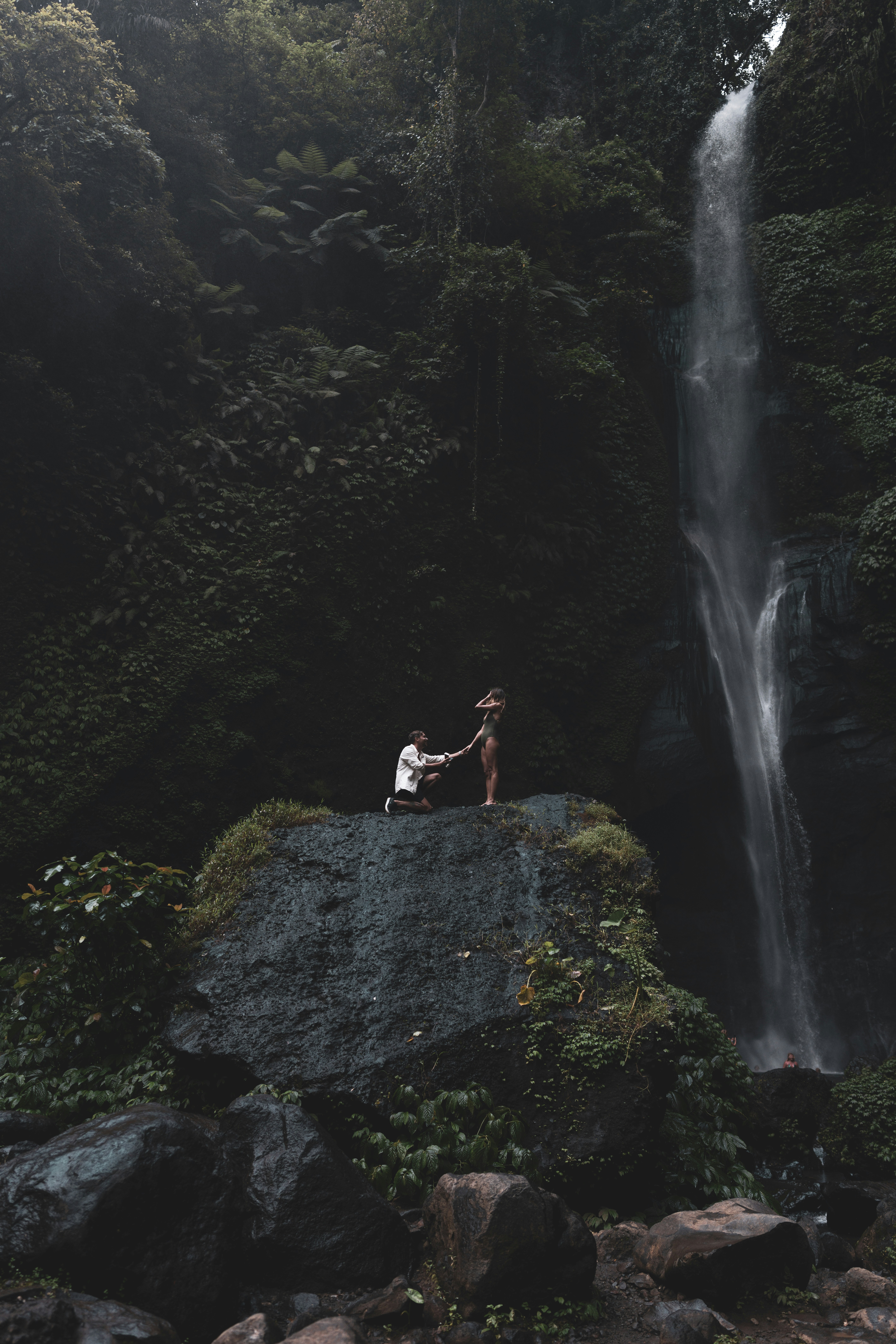 A couple on the rock near the waterfalls