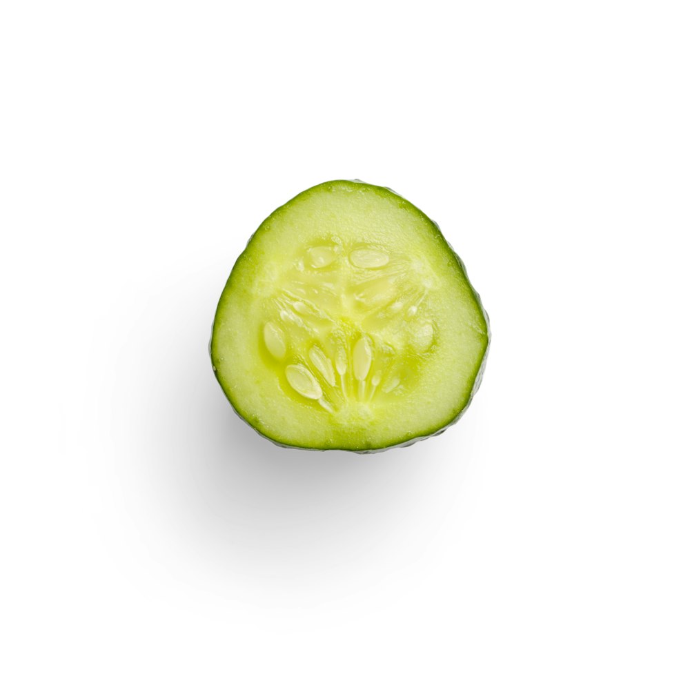 a cucumber cut in half on a white background