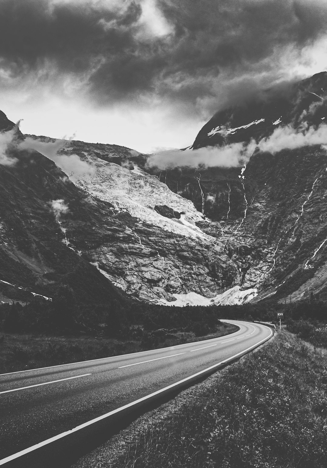 grayscale photo of road near mountain