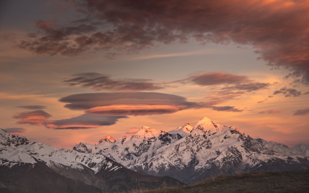 snow covered mountain under cloudy sky during daytime