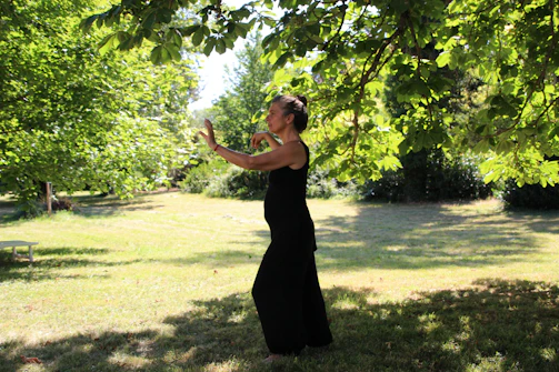 Close-up of hands practicing qi gong in a peaceful garden setting