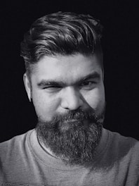 A professional portrait of Dami MacGregor, showcasing his charismatic presence.