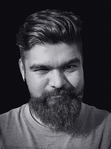 A professional portrait of Dami MacGregor, showcasing his charismatic presence.