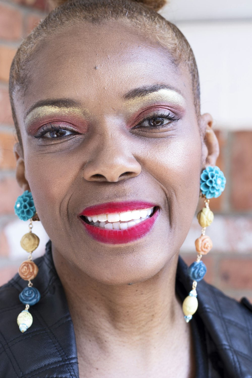 woman in blue and white beaded earrings