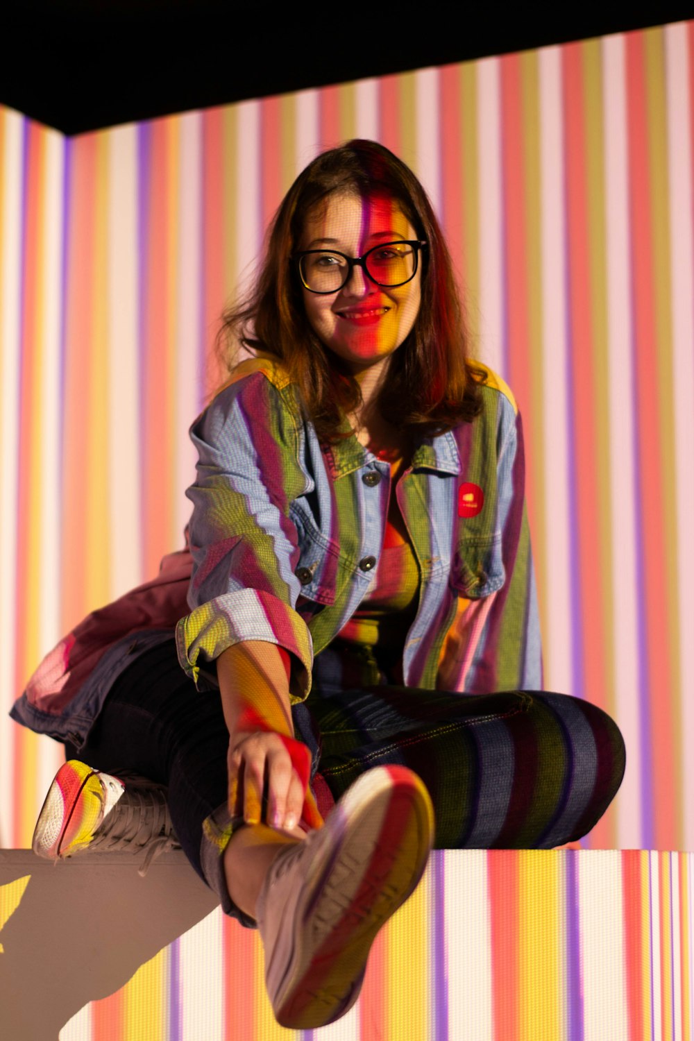 woman in green jacket sitting on chair