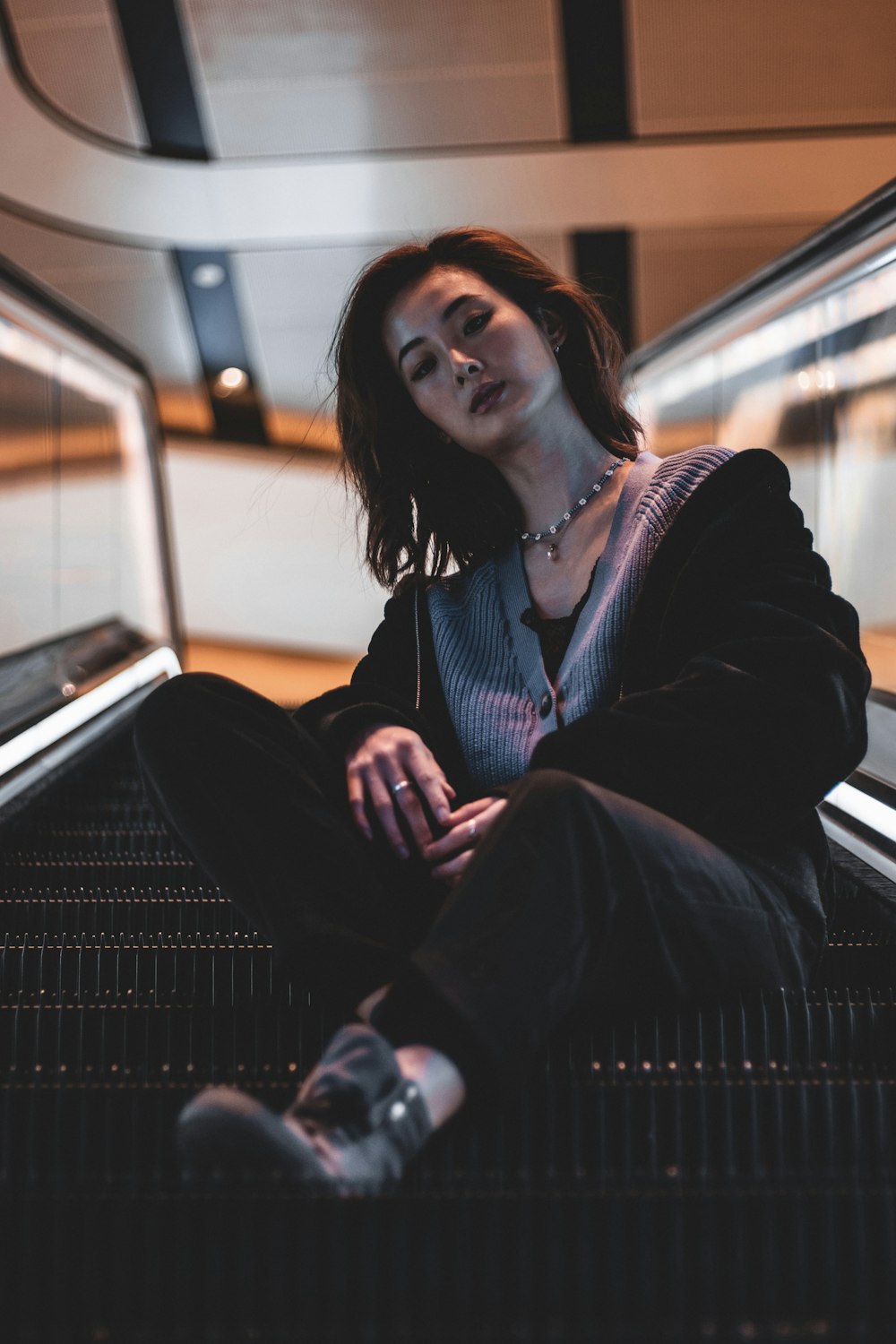 woman in black blazer sitting on train