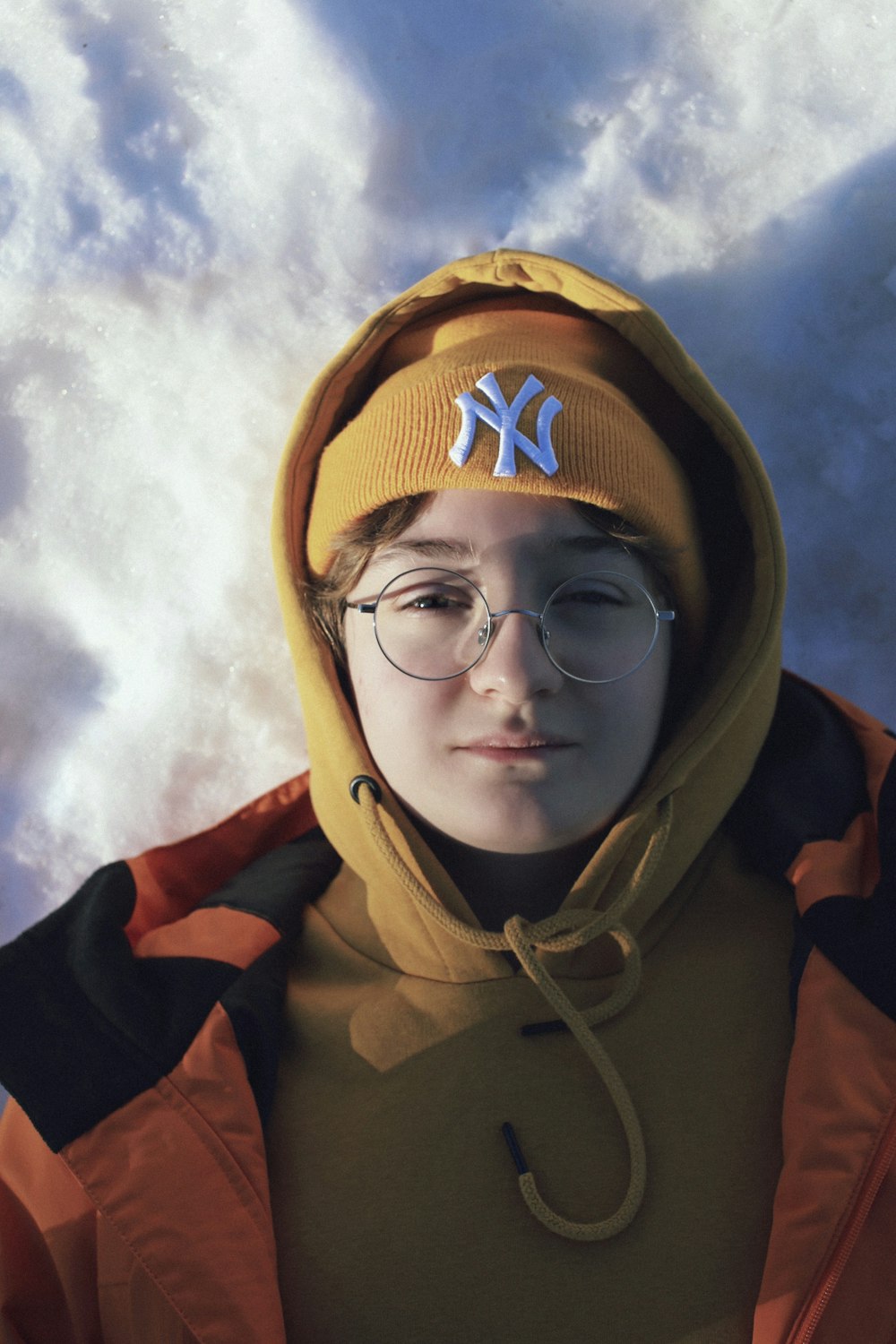 man in black hoodie wearing brown and orange under cloudy sky during daytime