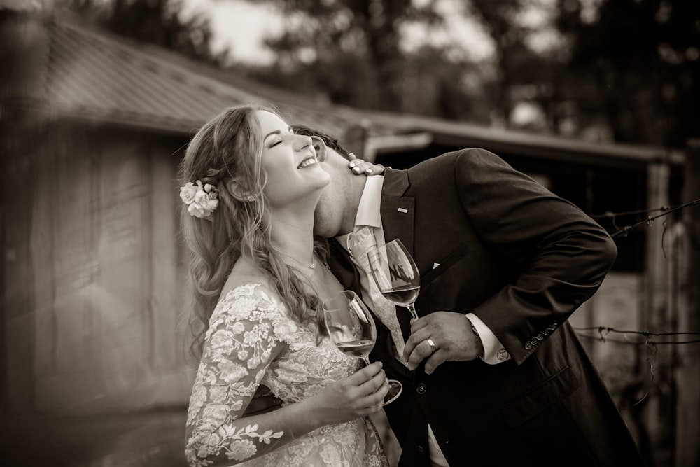 grayscale photo of couple kissing